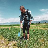 WAFERx graduate student, Hannah Goemann, applying blue-green algae biofertilizer to switchgrass bioenergy crops in Bozeman, MT.